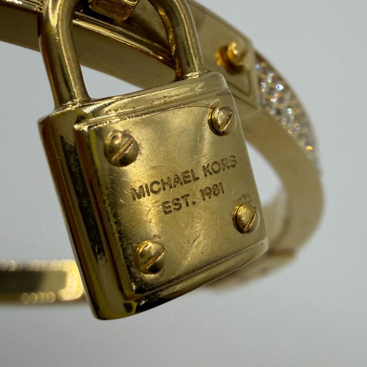 Michael Kors Goldtone Crystal Lock Hinged Bracelet With Pouch