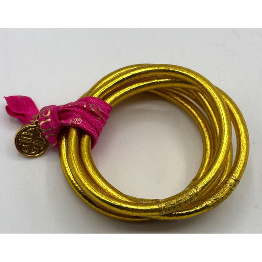 Set Of 5 Gold BudhaGirl All Weather Bangles With Pink Tassel & Charm